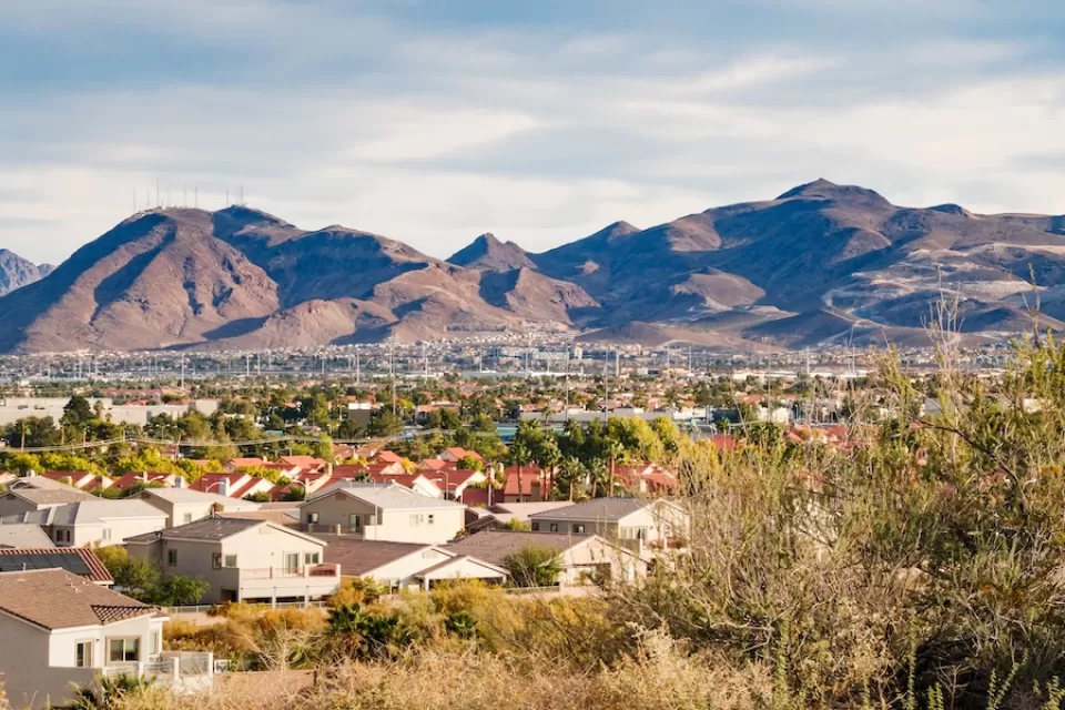 View of large homes in Henderson, Nevada with desert mountains in background.